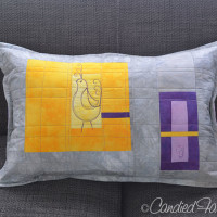 A Pillow for a Purple, Gold and Grey Baby’s Room